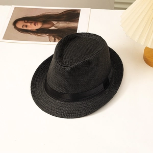Detail of black straw fedora hat featuring a fine weave and matching black satin ribbon