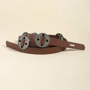 Close-up of brown leather belt with vintage metal floral carved buckles for women