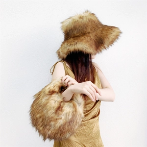 Detail of fluffy faux fur hat and matching handbag set in brown gradient for winter warmth