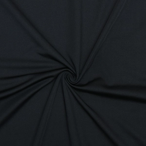 Close-up of black ruched dress fabric showing fine knitted texture and soft material