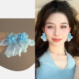 Close-up and model view of blue floral earrings with layered acrylic petals and tulle