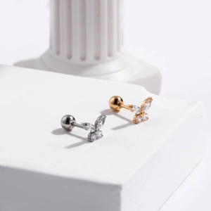 Detailed view of butterfly cartilage studs in gold and silver finish with zircon inlays