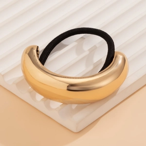 Detailed view of the thick gold metal curved buckle and black elastic hair tie