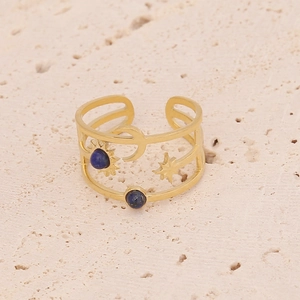 Golden multi-layer open ring with blue stones and celestial sun moon star motifs