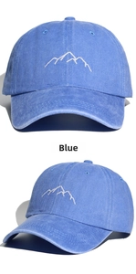 Close-up of blue washed cotton baseball cap with white mountain embroidery and vent holes