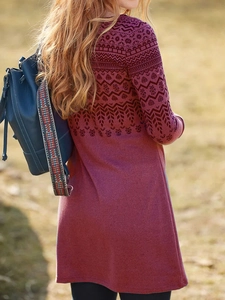 Detail of bohemian geometric print on long-sleeve burgundy dress with ethnic backpack