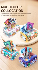 Detail of soft fabric tissue box toy for babies featuring dinosaur and space themes