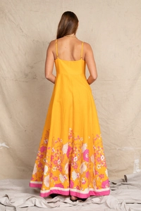 Back view of a yellow floral maxi dress with pink trim for beach vacation style