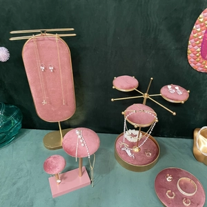 Pink velvet and gold metal jewelry display stands for necklaces and earrings