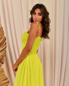 Detail of smocked bodice and adjustable tie straps on a solid color maxi dress