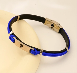 Détail du bracelet nautique en corde tressée bleue et cuir noir avec fermoir ancre en acier