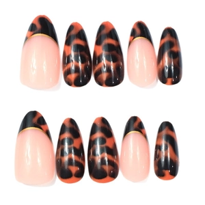 Short almond press-on nails with amber leopard print and French golden line design