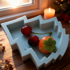 Detailed view of a blue Christmas tree silicone mold with snacks in a festive setting