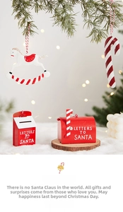 Close-up of red metal Santa letter box and festive ornaments with warm bokeh lights
