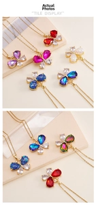 Detail display of butterfly pendants in various colors with zircon inlay and gold chain