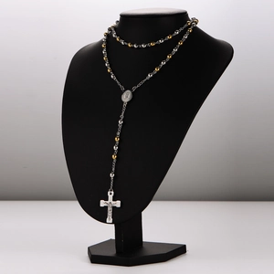 6mm silver and gold beaded rosary necklace with cross pendant on black mannequin