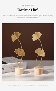 Detailed close-up of golden metal ginkgo leaf ornaments with realistic vein textures