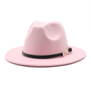 Detailed shot of pink fedora hat featuring black leather band and gold buckle detail