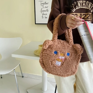 Close-up of a brown fuzzy plush tote bag with cute bear ears and detailed embroidery