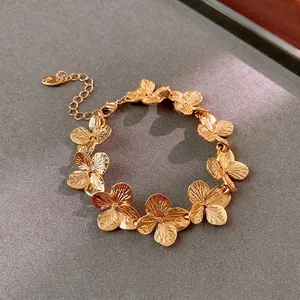 Elegant gold hydrangea flower bracelet with textured petals and adjustable lobster clasp