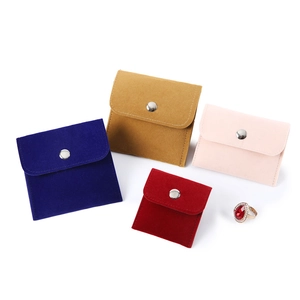 Microfiber velvet jewelry pouches with snap button in assorted colors and a ruby ring