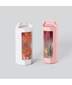 Detail of pink and white octagonal gift boxes with handle and clear window for flowers