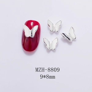 Macro detail of 9x8mm hollow metal butterfly nail charms with shiny silver finish