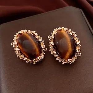 Vintage oval tiger eye earrings with gold filigree frames and elegant palace style design