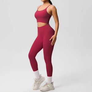 Deep red yoga set featuring thin strap sports bra and high-waist leggings side view