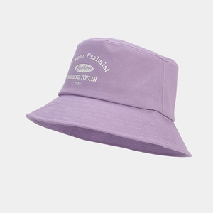 Detail view of purple cotton bucket hat with white printed letters and neat stitching