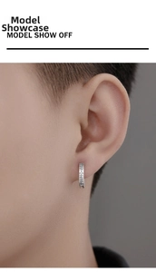 Detailed close-up of 925 silver hoop earring with roman numerals and inlaid diamonds