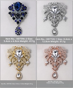 Detailed view of luxury crystal floral brooches with teardrop pendants in four elegant colors