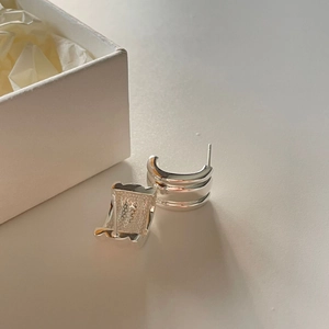 Minimalist silver curved C-shape stud earrings with polished finish and textured inner side