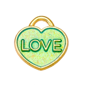 Macro shot of green glitter heart pendant with gold LOVE lettering DIY accessory
