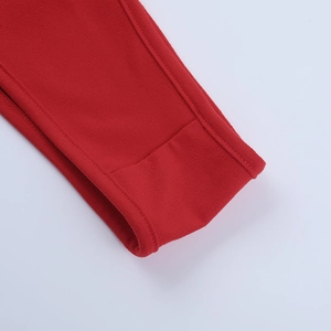 Detail shot of the red knitted cotton fabric texture and hem stitching on a beach set