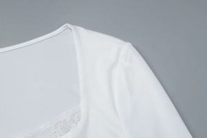 Detailed view of the lace trim and square neckline on the white slim-fit top