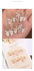 Detail of pink almond nails with white lace, 3D bows, pearls and floral patterns