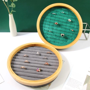 Round bamboo jewelry display tray with dark green and grey velvet lining for rings