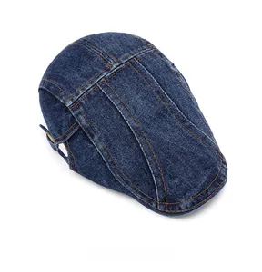 Detailed top view of blue denim flat cap with contrast orange stitching and metal buckle