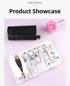 Close-up of portable jewelry organizer roll with necklace hooks and ring storage strips