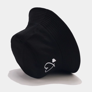 Close-up of heart embroidery on black cotton bucket hat with detailed canvas texture