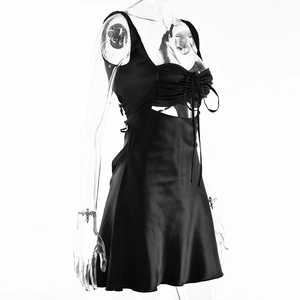 Detail of black satin dress featuring pleated bust tie and side waist cutouts