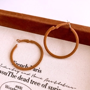 Retro caramel flocked hoop earrings with a large circular design and matte velvet finish