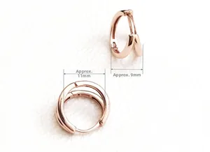 Macro detail of rose gold double hoop earrings with 9mm width and 11mm diameter dimensions