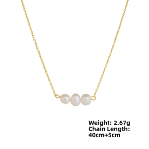 Detailed close-up of three white freshwater pearls on a gold 925 silver chain necklace