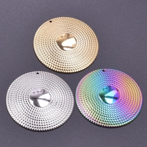 Macro detail of round 18k plated stainless steel pendants in gold silver and rainbow