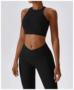 Close-up of high-waist criss-cross leggings and ribbed athletic tank top on a fitness model