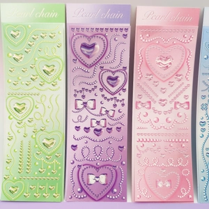 Detail of 3D embossed stickers with pearl chains and heart gems in green, purple, and pink