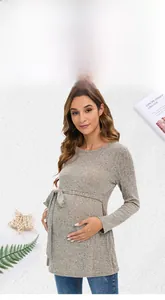 Detail of grey knit maternity sweater featuring adjustable waist tie and ribbed texture