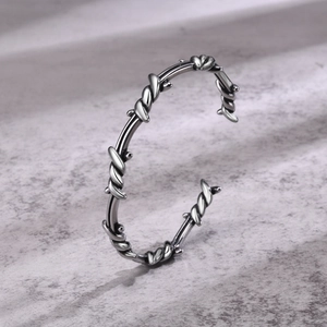 Detailed shot of men's vintage silver cuff bracelet featuring twisted wire textures
